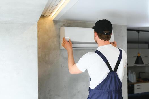 Technician servicing an indoor air conditioner