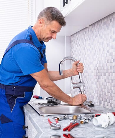 Plumber repairing a water fitting