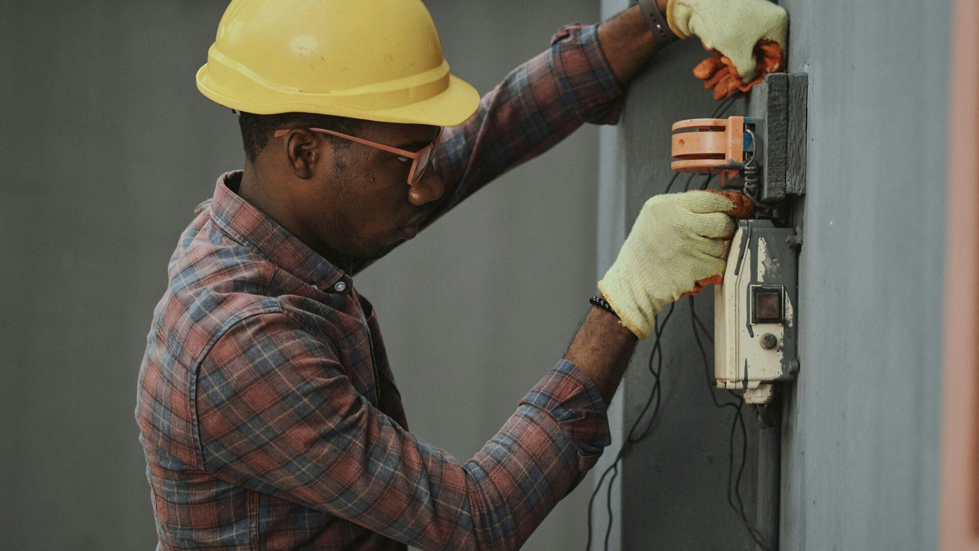 Electrician replacing a wall socket